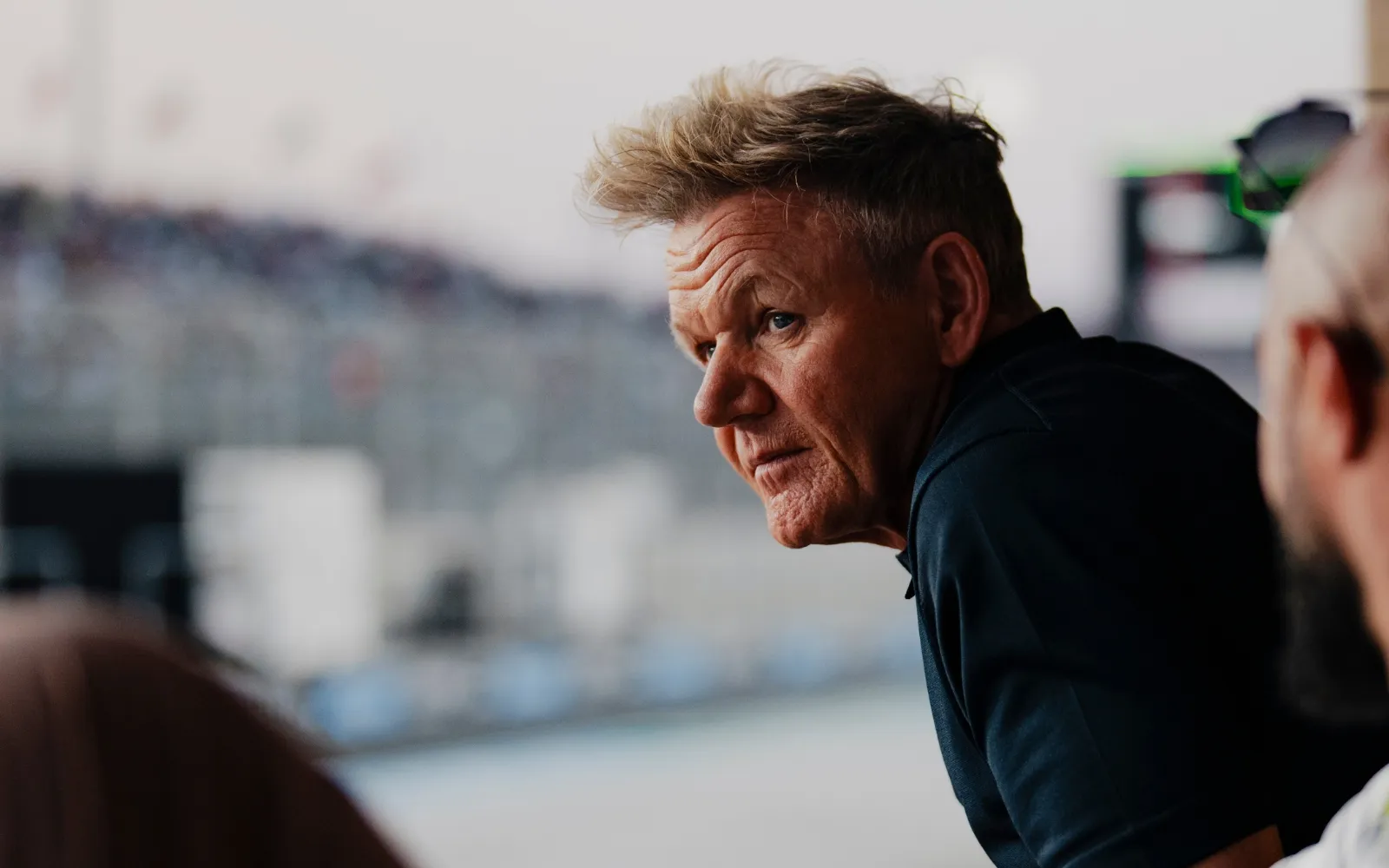 Gordon Ramsay watching on-track Formula 1 action from F1 Garage hospitality suite