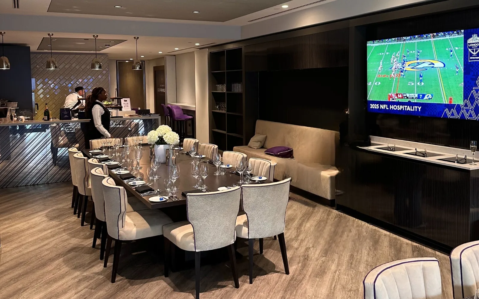 Luxury Super Suite featuring a dining area, lounge seating, bar service and large screen entertainment.