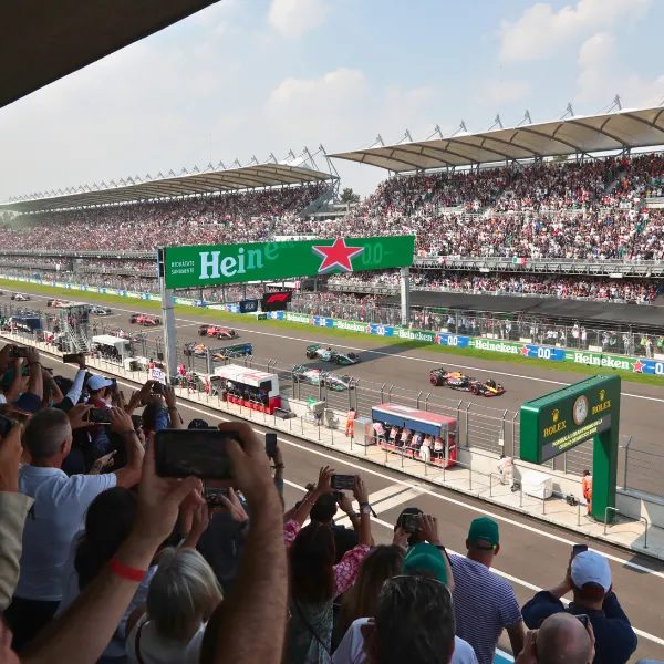 Formula 1 race start with cars on track and grandstand crowd