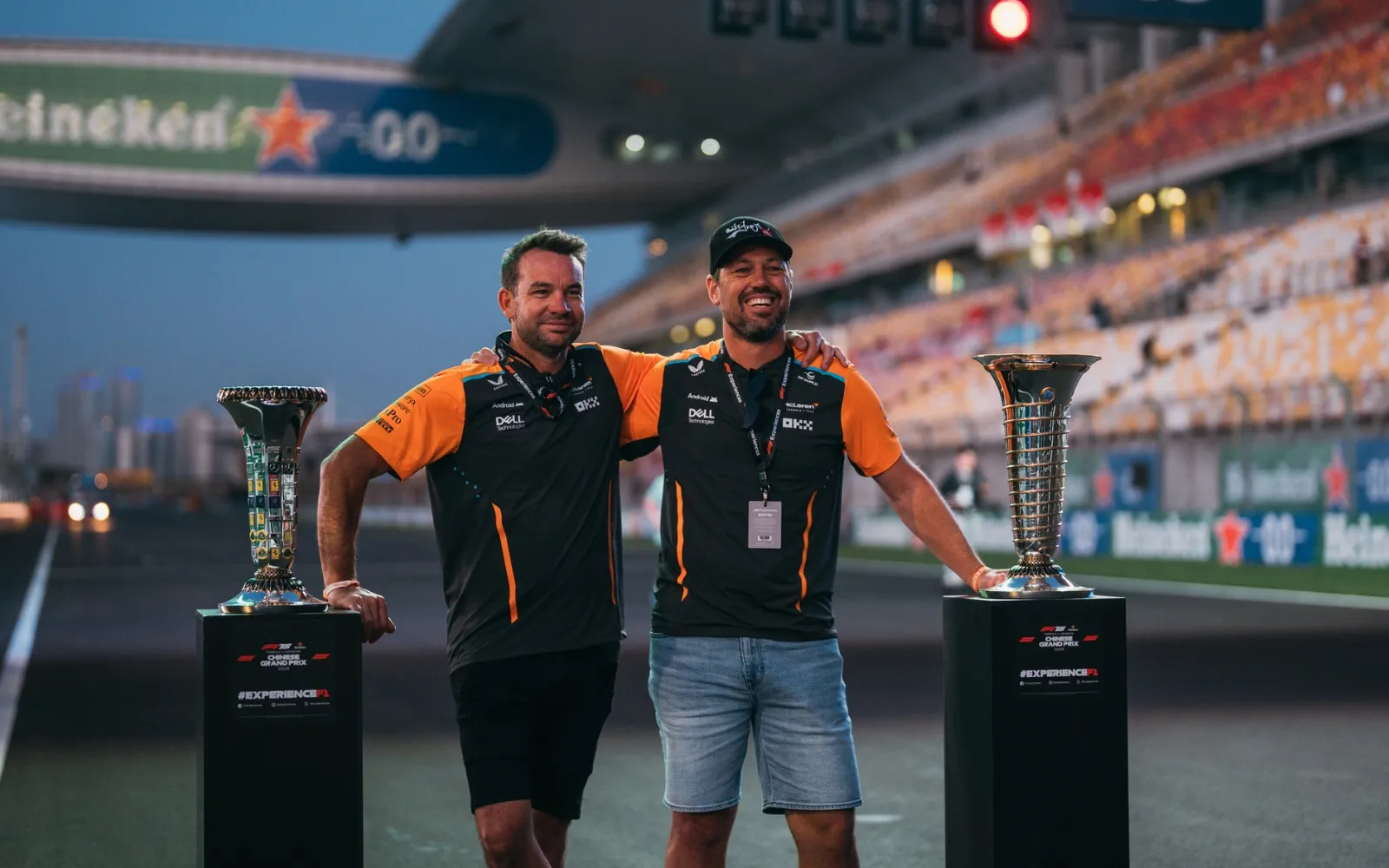Guests with Formula 1 trophies on track during F1 Paddock Club Hospitality experience