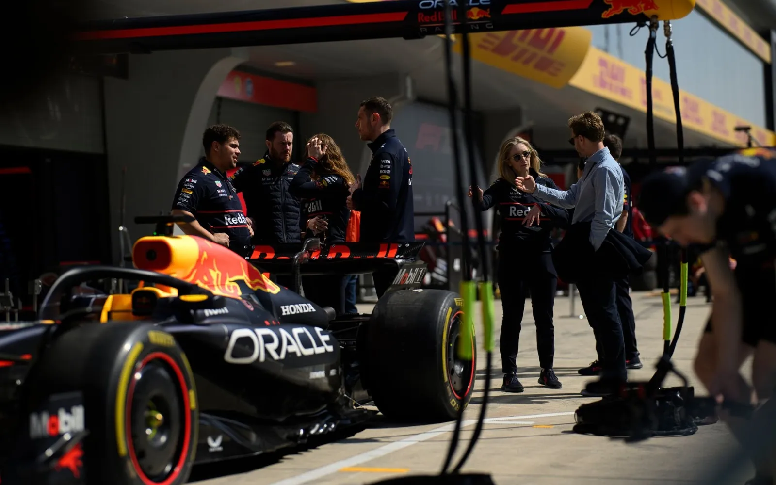 Red Bull Racing team performing live Formula 1 pit stop in pit lane