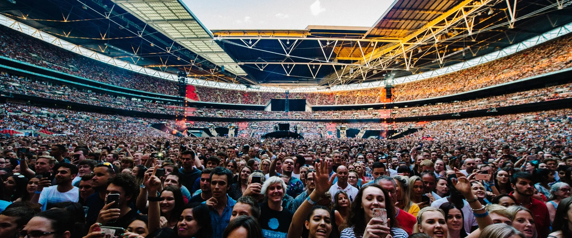 Harry Styles Wembley Stadium concert crowd with full stadium atmosphere and premium seating views